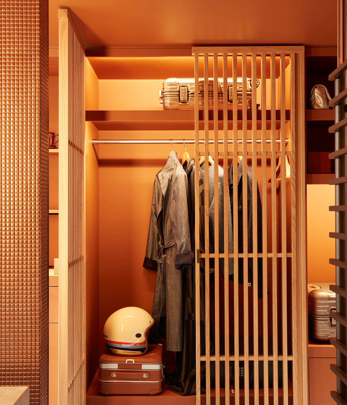 Wardrobe space with hangers and place for luggage.
