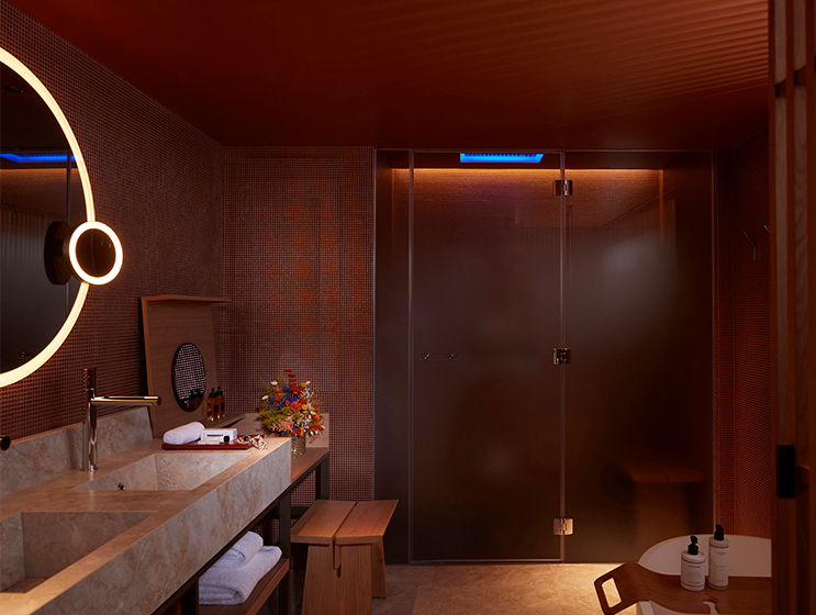 Spacious bathroom with double vanity sink, illuminated mirror and hammam shower