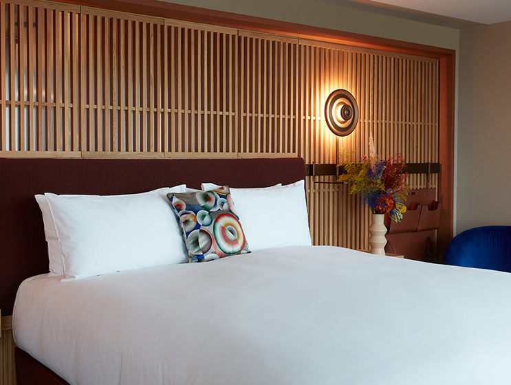 Full view of King bed with mounted bedside tables and lights