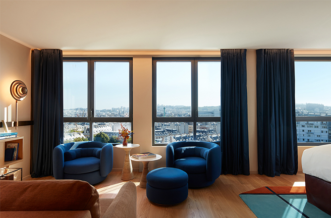 http://Full%20view%20of%20seating%20area%20with%20armchairs%20and%20couch%20overlooking%20Paris