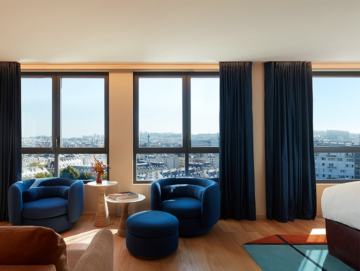 Full view of seating area with armchairs and couch overlooking Paris