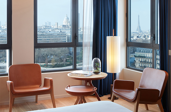 http://Seating%20area%20-%20two%20wooden%20chairs%20and%20coffee%20tables%20-%20and%20view%20of%20Paris%20Skyline