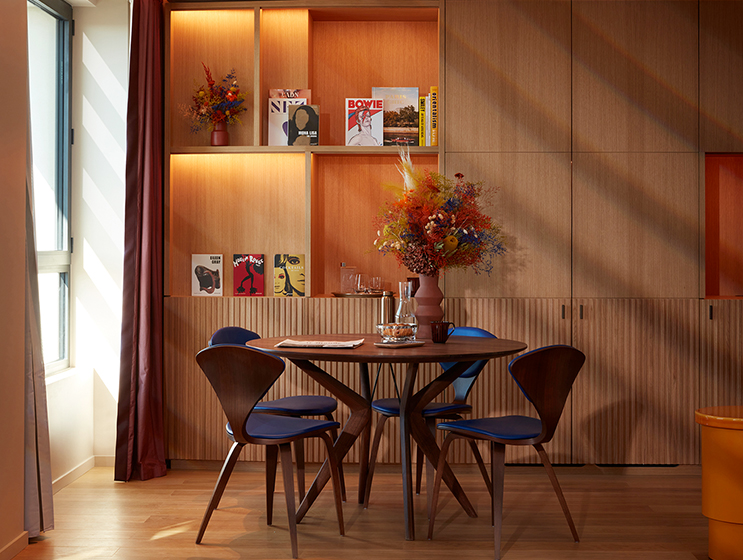 Small rounded kitchen table and chairs topped with flowers