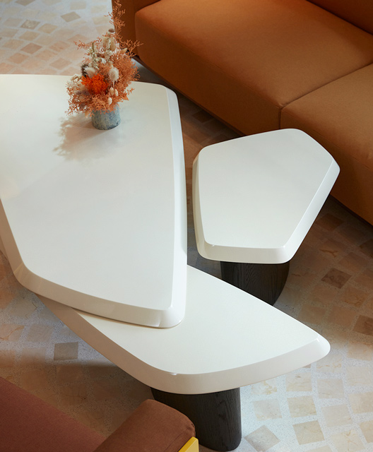 http://Modern%20white%20coffee%20table%20with%20bronze%20coloured%20couches%20either%20side