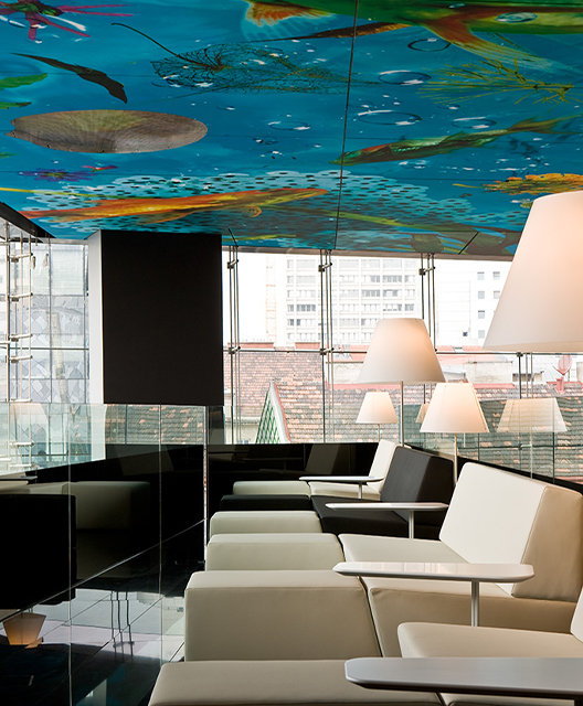 http://A%20row%20of%20white%20loungers%20underneath%20a%20beautiful%20mural%20on%20the%20ceiling
