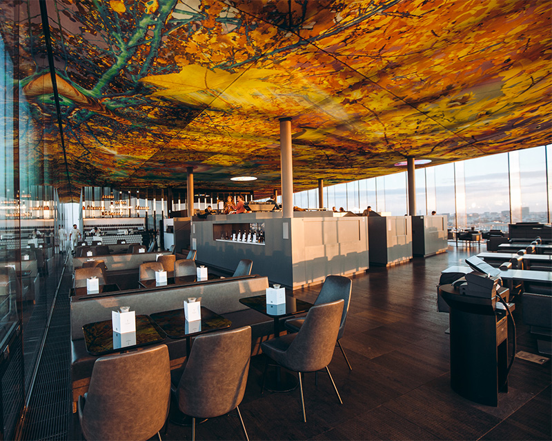 http://A%20large%20restaurant%20underneath%20a%20beautiful%20ceiling%20mural%20with%20a%20bar%20in%20the%20centre%20of%20the%20space%20and%20full%20length%20windows%20overlooking%20the%20Viennese%20skyline