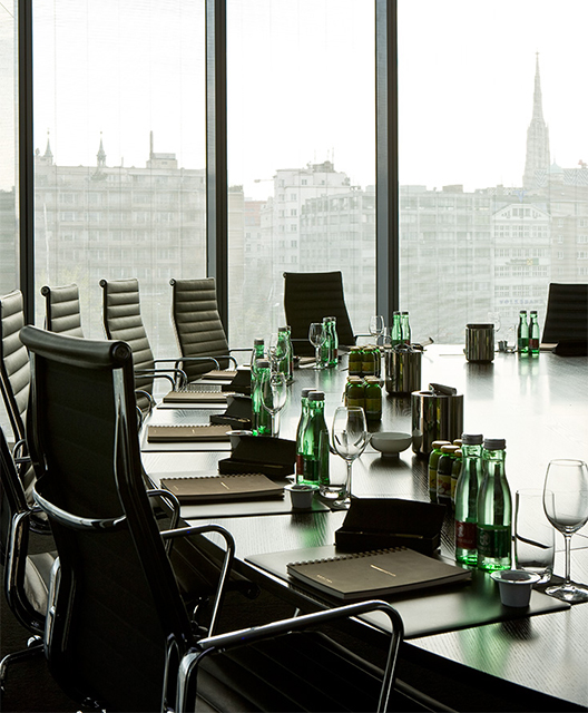 http://A%20round%20meeting%20table%20next%20a%20full%20length%20window%20with%20a%20view%20of%20Vienna