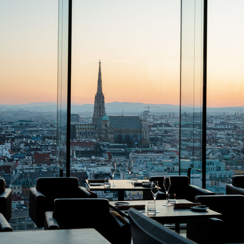 Floor to ceiling windows give a beautiful view of the Vienna city scape from a restarant.