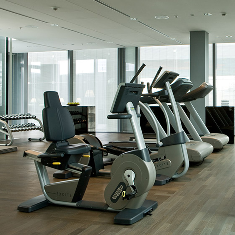 A row of ellipticals in a gray, black and white Fitness Gym