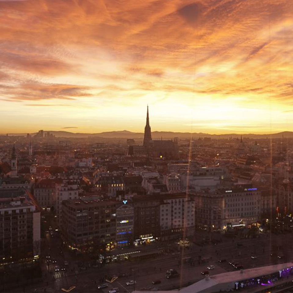 An incredible view of the Viennese skyline as the setting sun shines a beautiful orange glow over the city