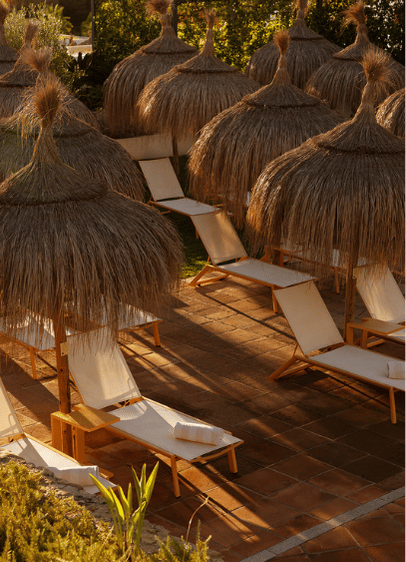 http://Several%20lounge%20chairs%20with%20umbrellas%20arranged%20neatly%20around%20a%20swimming%20pool,%20inviting%20relaxation%20on%20a%20sunny%20day.