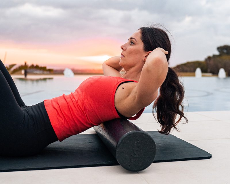 http://A%20woman%20laying%20on%20an%20exercise%20mat