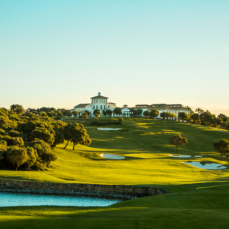 A large green golf course with several ponds