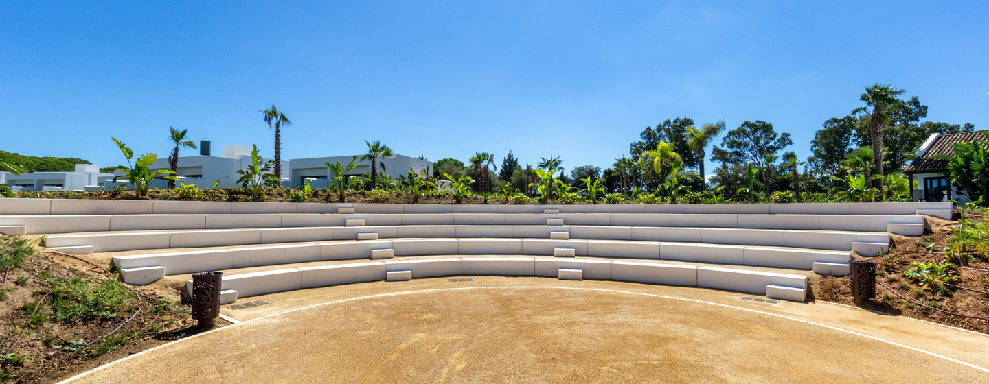 Large amphitheatre area surrounded by greenery