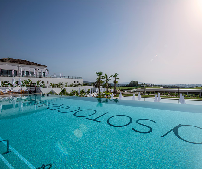 An clear blue inifity pool with 'SO/ Sotogrande' visible at the bottom. Below it is anoother pool