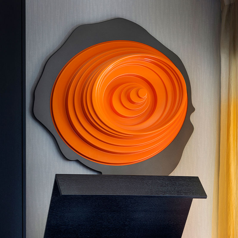A large orange emblem mounted on the wall
