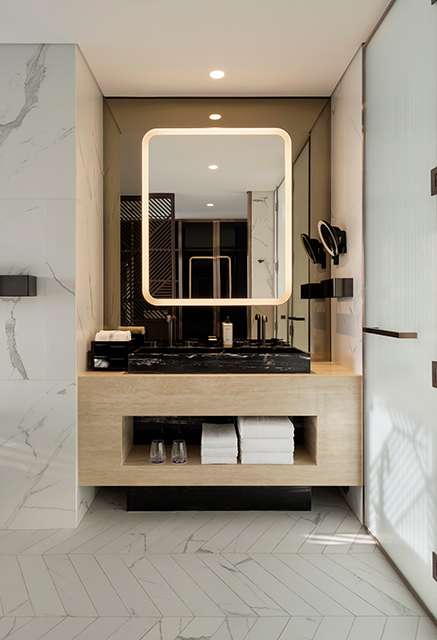 http://Surround-lit%20bathroom%20mirror%20with%20space%20for%20toiletries%20and%20marble%20walls.
