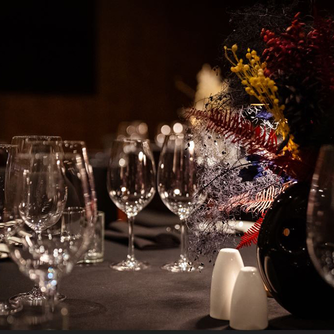 Wine glasses and festive decorations on a dining table