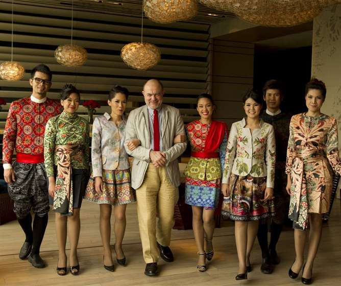 Designer Christian Lacroix stands with members of the SO/ Bangkok Hotel staff, dressed in his beautifully designed uniforms.