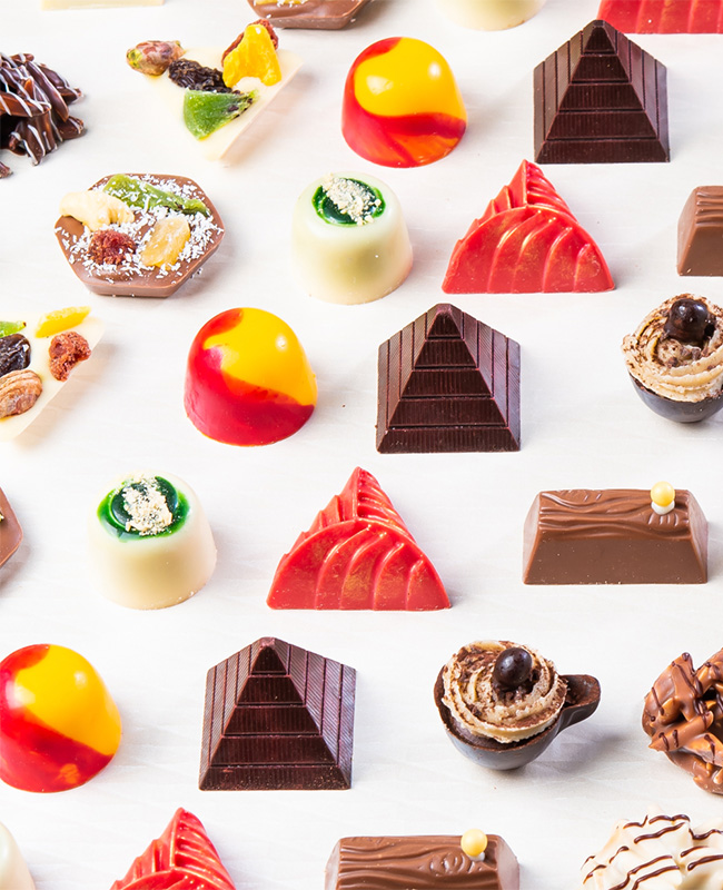 A selection of sweet treats and desserts lined up in neat rows.