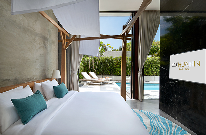 http://Luxurious%20hotel%20room%20featuring%20a%20king-sized%20bed,%20modern%20decor,%20and%20a%20view%20of%20a%20private%20pool%20through%20large%20windows.