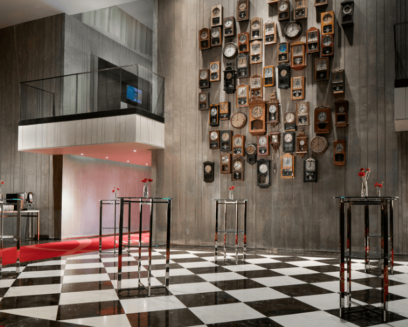 http://Luxury%20ballroom%20foyer%20at%20SO/%20Bangkok%20featuring%20a%20statement%20wall%20of%20vintage%20clocks%20and%20a%20stylish%20black-and-white%20checkered%20floor%20setup%20for%20events