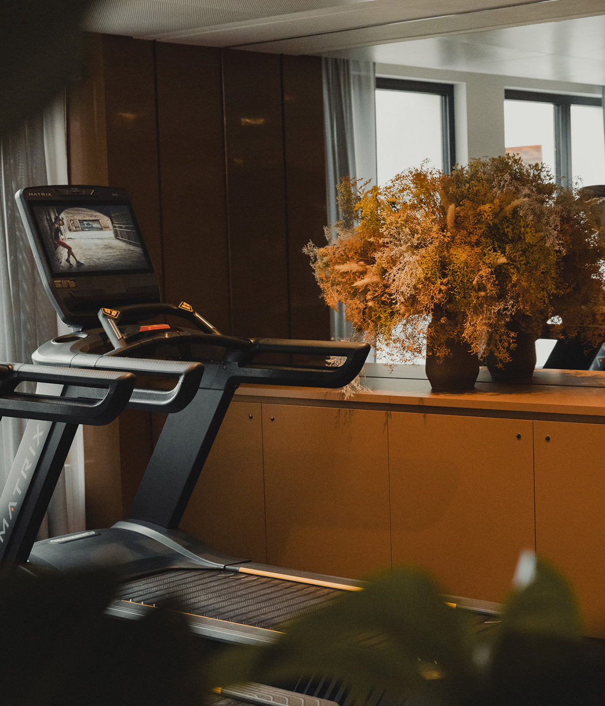 Treadmill next to a mirror in the hotel fitness room