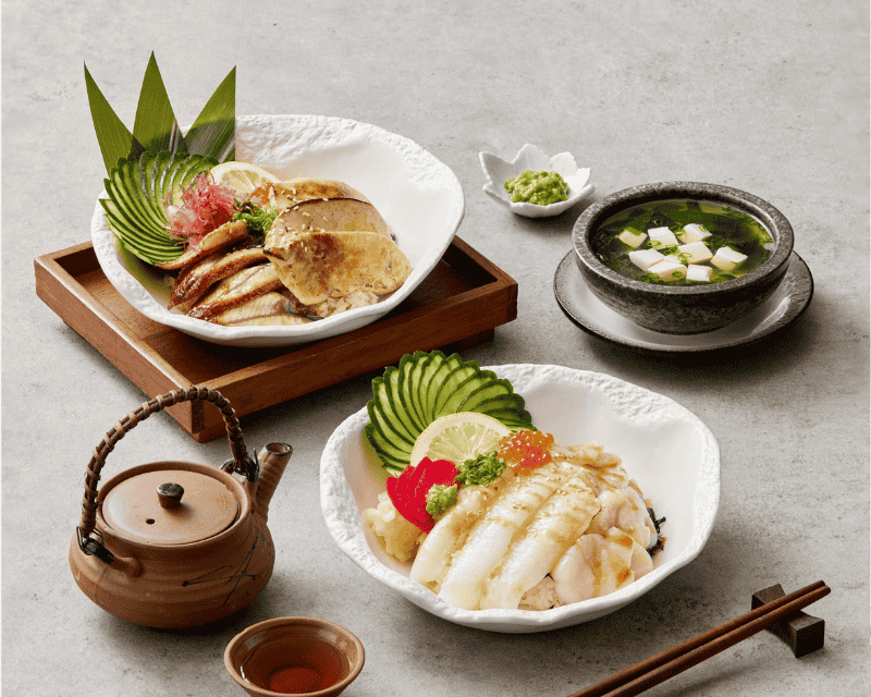 http://A%20Japanese%20culinary%20spread%20featuring%20a%20bowl%20of%20grilled%20eel%20(Unagi)%20with%20seared%20foie%20gras%20over%20rice,%20a%20bowl%20of%20seared%20white%20fish%20with%20salmon%20roe,%20and%20a%20side%20of%20hot%20miso%20soup%20with%20tofu.
