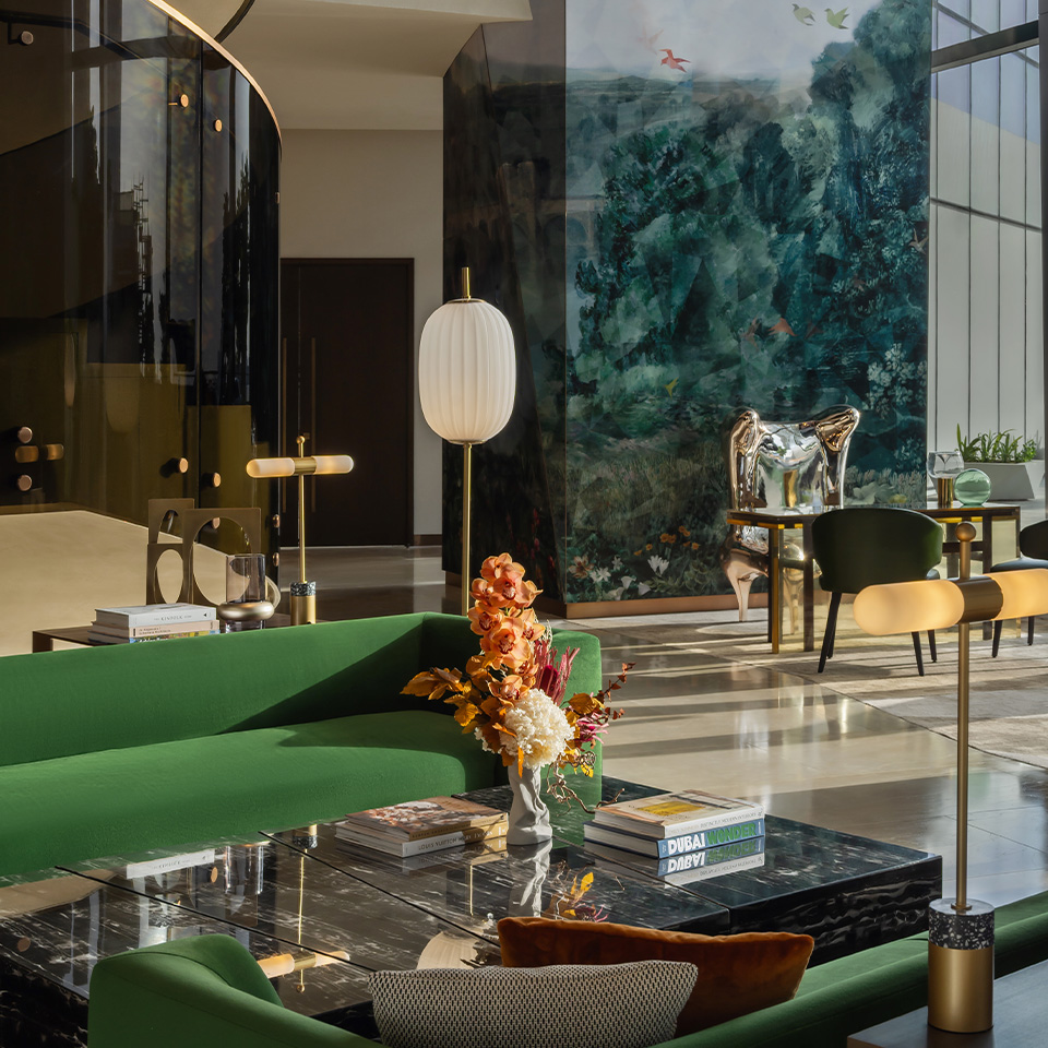 View of the dubai hotel lobby with green softa with marble coffee table.