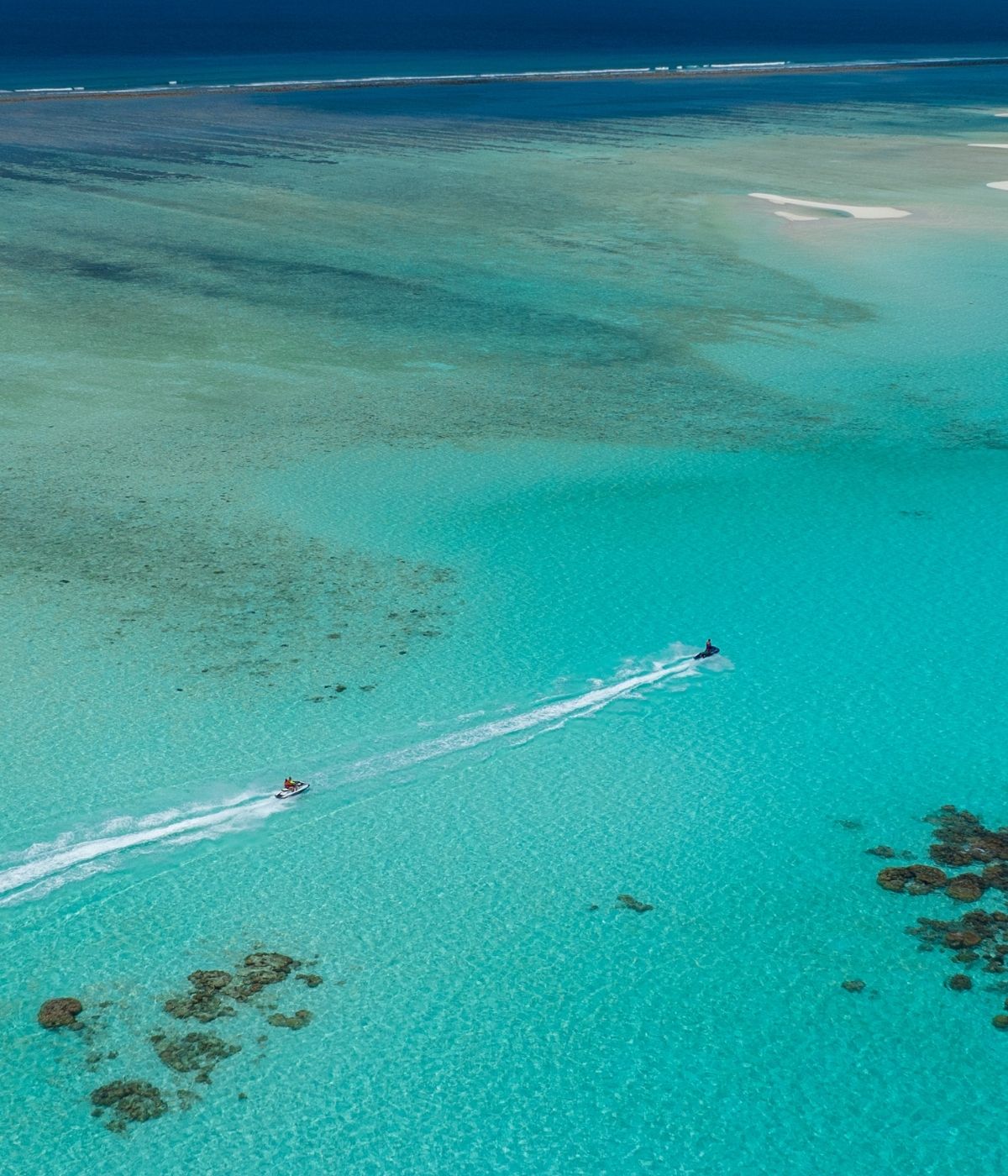 Jet ski seen from above, racing through the turquoise Waters.