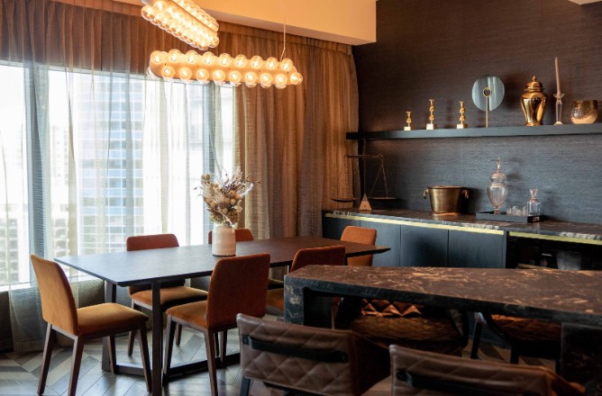 http://Modern%20dining%20area%20featuring%20a%20dark%20wood%20table,%20stylish%20chairs,%20large%20windows%20draped%20with%20curtains,%20and%20decorative%20shelves.