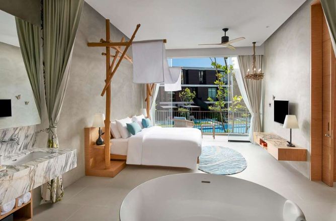 http://A%20luxurious%20hotel%20suite%20combining%20bedroom%20and%20bathroom,%20featuring%20a%20wooden%20canopy%20bed,%20a%20freestanding%20circular%20bathtub,%20a%20marble%20vanity,%20and%20a%20balcony%20overlooking%20a%20resort%20pool.