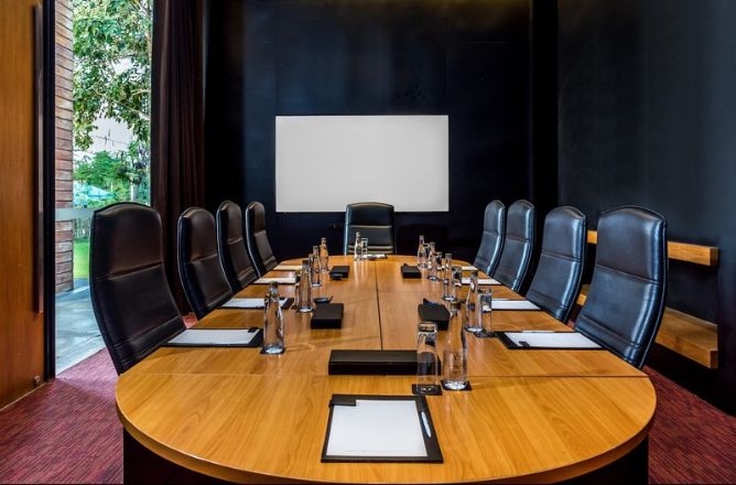 http://A%20sleek,%20modern%20conference%20room%20with%20a%20long%20wooden%20table,%20black%20leather%20chairs,%20and%20a%20sign%20reading%20SO%20Sofitel%20Hua%20Hin.%20Natural%20light%20filters%20in%20from%20a%20window%20on%20the%20left.