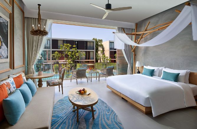 http://A%20modern%20hotel%20room%20features%20a%20canopy%20bed%20with%20white%20linens,%20a%20teal-accented%20sitting%20area,%20and%20a%20balcony%20view.%20The%20room%20is%20bright%20and%20inviting.
