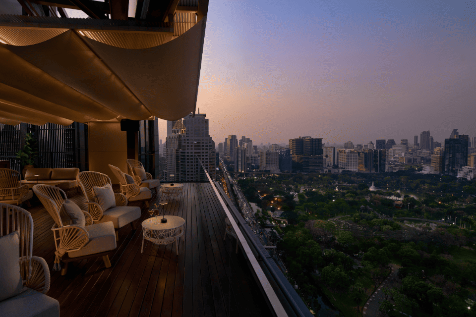 http://Iris%20Terrace%20offers%20relaxed%20rooftop%20lounge%20seating%20where%20guests%20enjoy%20sunset%20views%20across%20Lumphini%20Park%20and%20the%20Bangkok%20skyline.