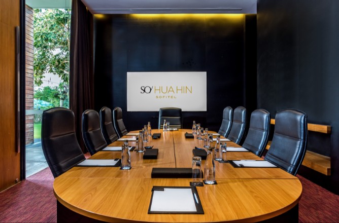 http://A%20sleek,%20modern%20conference%20room%20with%20a%20long%20wooden%20table,%20black%20leather%20chairs,%20and%20a%20sign%20reading%20SO%20Sofitel%20Hua%20Hin.%20Natural%20light%20filters%20in%20from%20a%20window%20on%20the%20left.