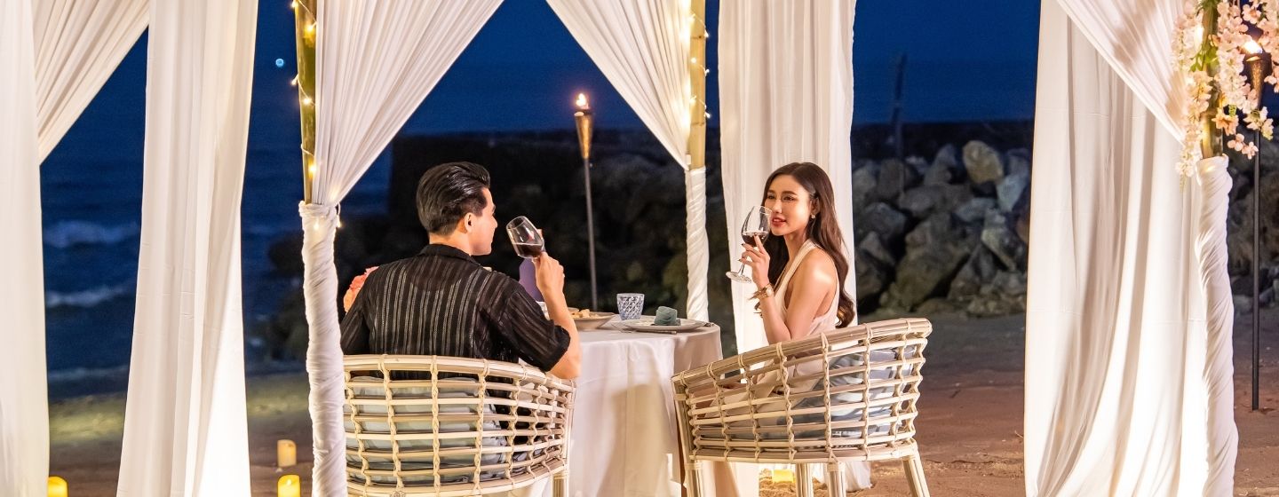 Romantic private dining experience on the beach at night under a lighted canopy at SO/ Sofitel Hua Hin
