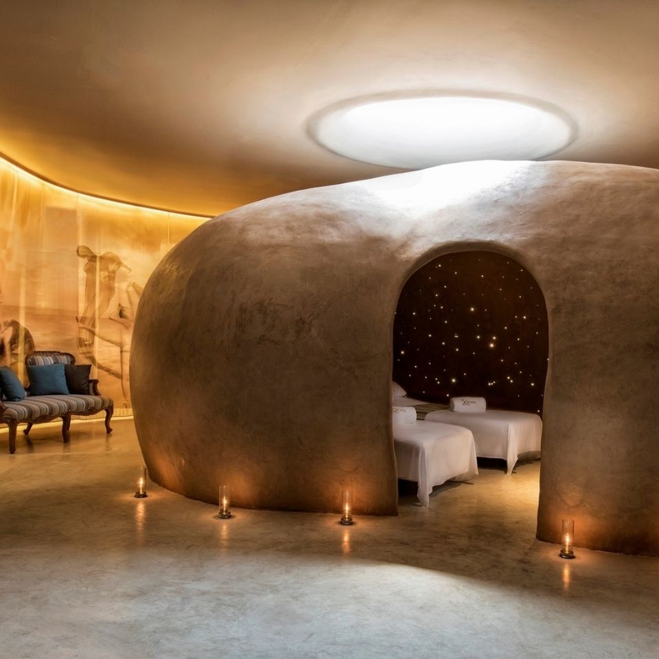 Cocoon-shaped spa treatment room with a relaxing candlelit atmosphere and massage beds at SO/ Sofitel Hua Hin