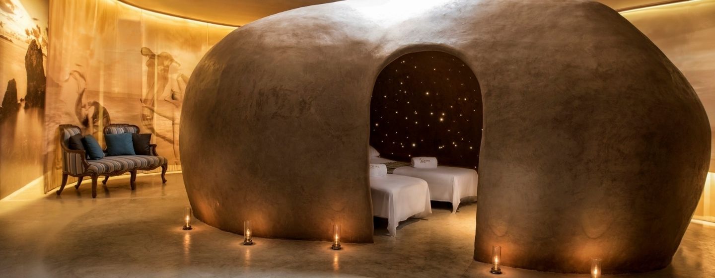 Cocoon-shaped spa treatment room with a relaxing candlelit atmosphere and massage beds at SO/ Sofitel Hua Hin