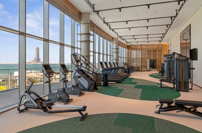http://A%20state-of-the-art%20hotel%20fitness%20center%20with%20treadmills,%20stationary%20bikes,%20and%20weight%20machines,%20featuring%20floor-to-ceiling%20windows%20with%20a%20panoramic%20view%20of%20the%20sea.