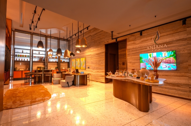 http://The%20opulent%20reception%20lobby%20of%20Anjana%20Spa,%20featuring%20polished%20marble%20floors,%20travertine%20stone%20walls,%20a%20display%20of%20sensory%20jars,%20and%20warm%20artistic%20pendant%20lights%20hanging%20above%20the%20lounge.